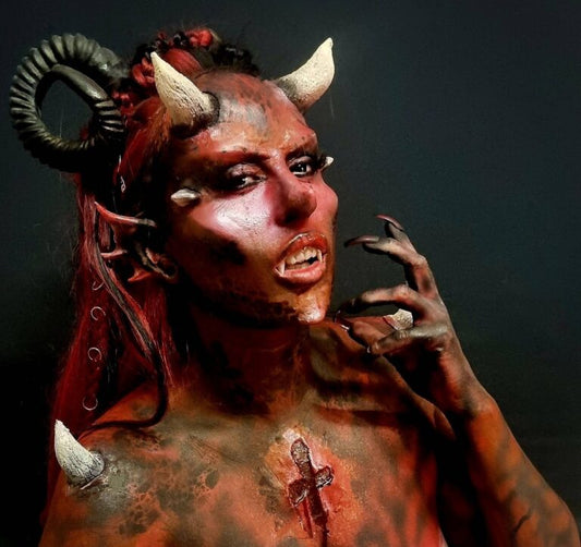 Pointy silicone cheekbones and brow prosthetics.